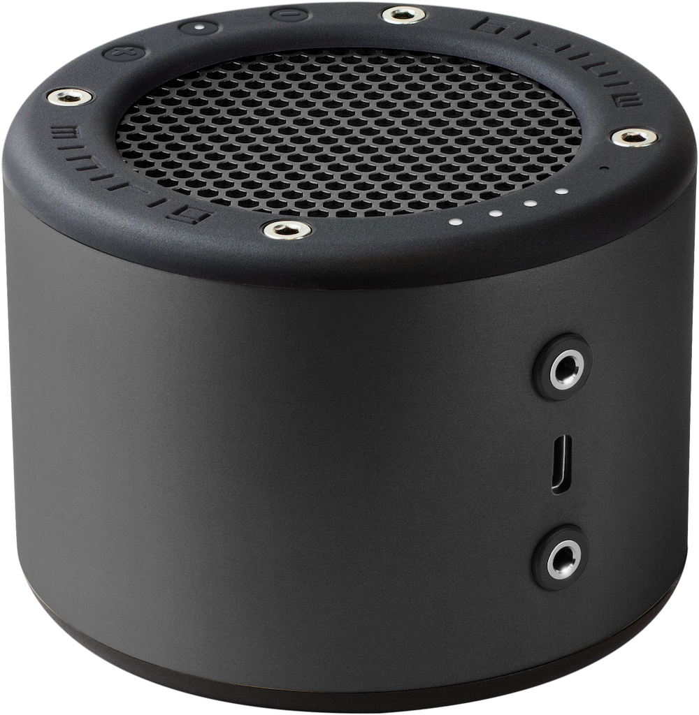 The Minirig 4. It is a small black cylinder with a grill at one end. It has silver two silver audio outputs and a usb charging port. 