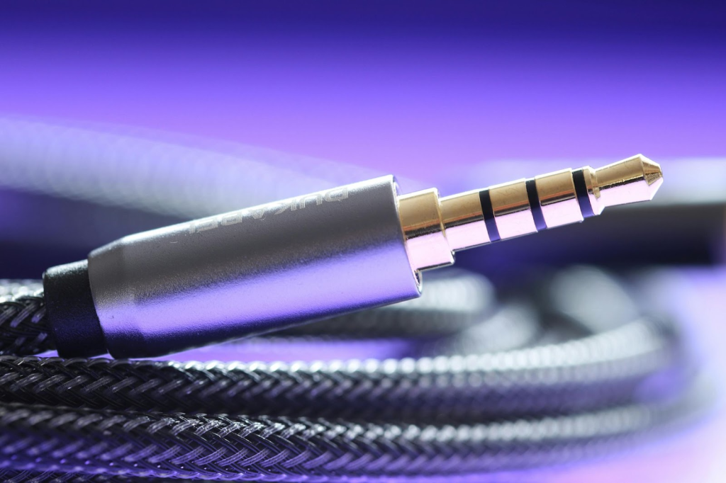 A silver mini jack to mini jack cable. 